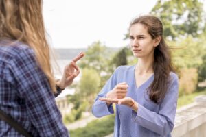 adult women communicating through sign language